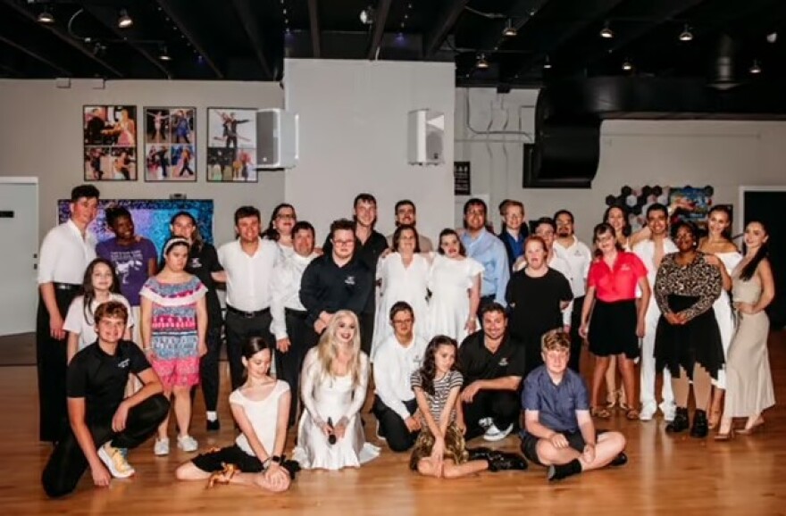 Sarah Lototskyy (bottom row, in white dress) with some of the dancers in the nonprofit Dynasty Stars, which provides ballroom instruction and Pro-A, competition opportunities for students with special needs.