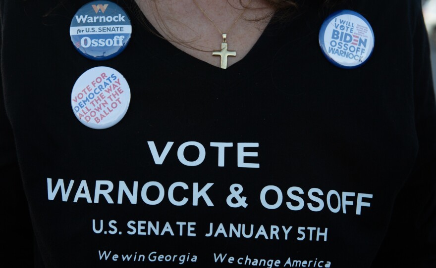 A supporter wears a homemade T-shirt to promote Democratic U.S. Senate candidates Jon Ossoff and Raphael Warnock of Georgia during a rally on Nov.15, in Marietta, Ga.