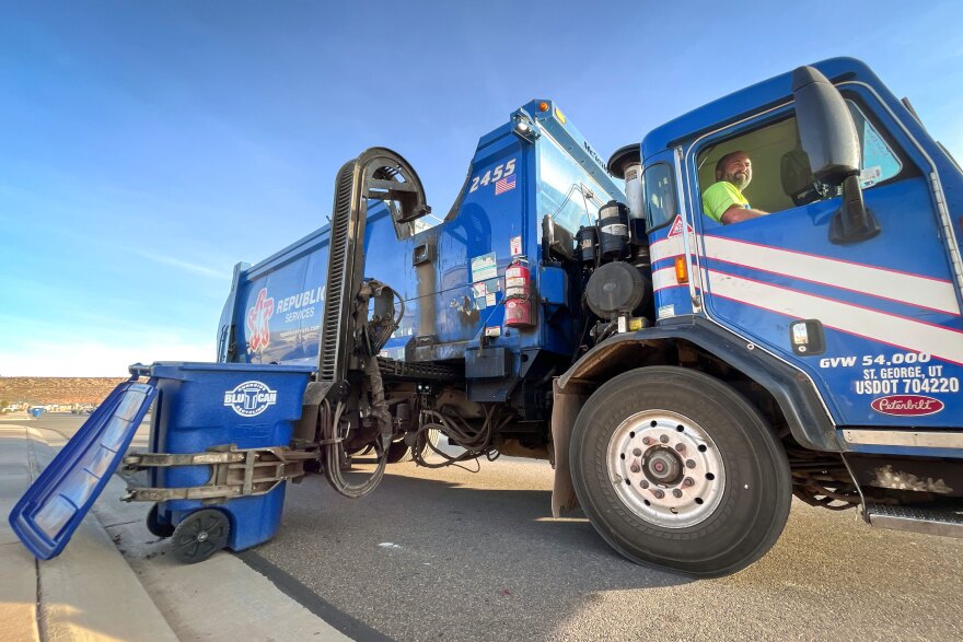 A truck picks up a curbside recycling bin in St. George, Utah, Dec. 17, 2024. While Washington County offers a public recycling program, neighboring areas aren’t so lucky.