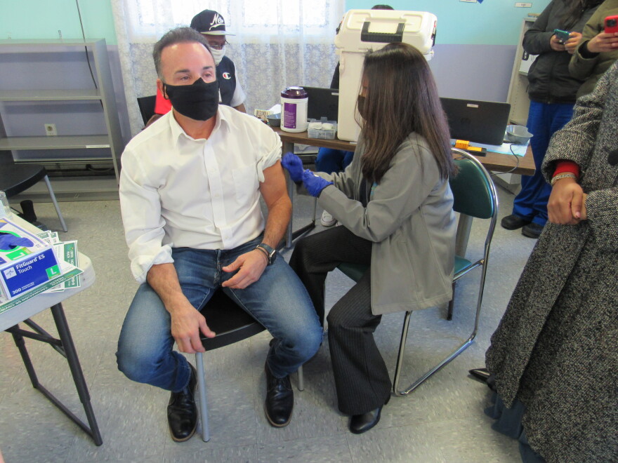 Manisha Juthani, Connecticut's public health commissioner, administers a Moderna COVID-19 booster shot to Bridgeport Mayor Joe Ganim at a mobile vaccine clinic at the Thomas Merton Center in Bridgeport.