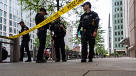 U.S. Secret Service Police officers place crime scene tape after a copper jacket of a bullet was found near the scene of a shooting close to the White House, Sunday, May 24, 2026, in Washington. (AP Photo/Alex Brandon)