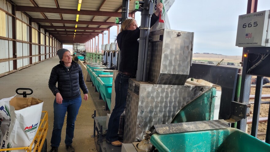  Sara Place and Kim Stackhouse Lawson restocking the GreenFeed machines with a fresh supply of alfalfa pellets. The machines dispense the pellets to lure cattle in for a snack, giving researchers the opportunity to analyze their emissions. 