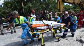 Rescue workers retrieve a dead body in a damaged building on Aug. 24, 2016 in Accumoli, Italy. (Giuseppe Bellini/Getty Images)
