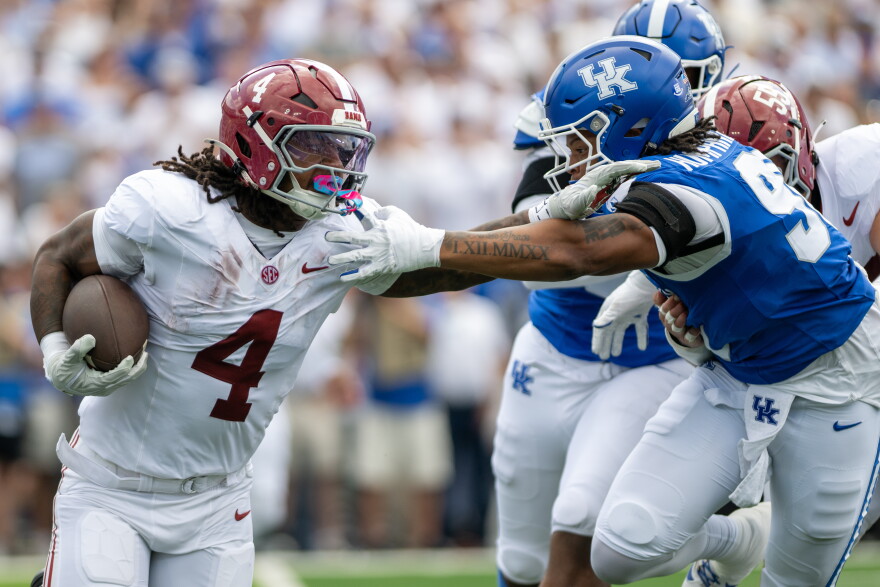 Alabama running back Daniel Hill (4) holds off Kentucky defensive lineman Mi'Quise Humphrey-Grace (90) during the first half of an NCAA college football game, Saturday, Sept. 12, 2026, in Lexington, Ky. (AP Photo/Tony Wagner)