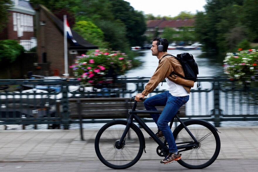 A man rides a VanMoof brand e-bike in Amsterdam, Netherlands, Aug. 17.