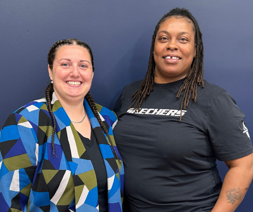 photo of two women smiling next to eachother 
