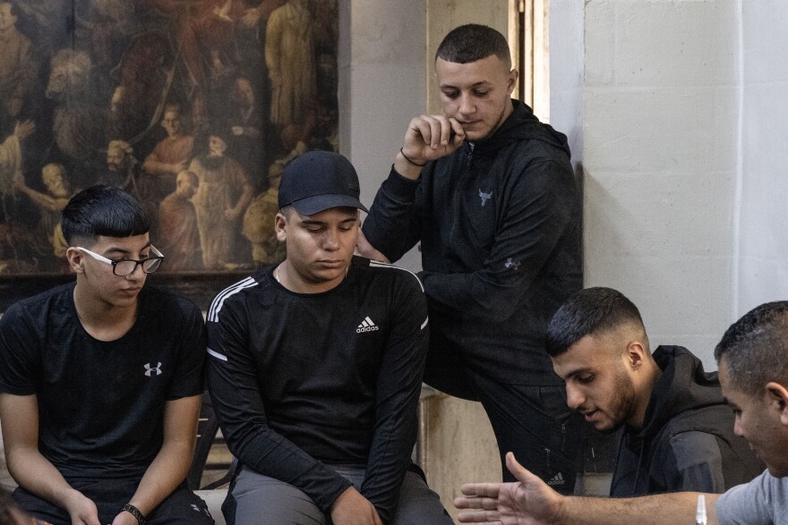 A group of young men, sit and listen to political questions and share their hopes for the future in Ramallah, the West Bank, on Oct. 31, 2023.