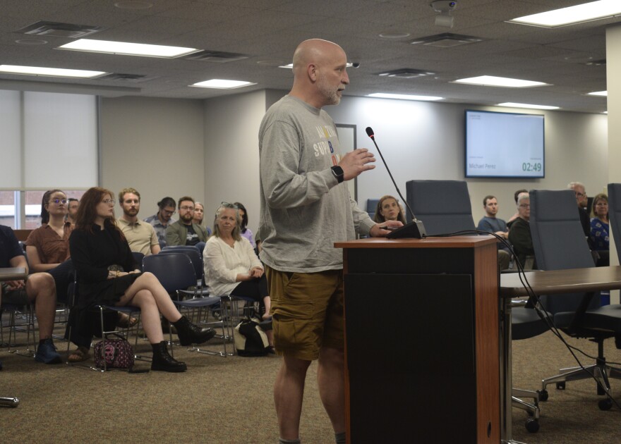 A man speaks during public comment at a city council meeting