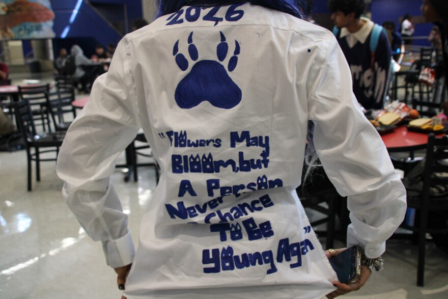 Dayona Harris, a senior at Central High School, painted a quote from the children’s animated series “Bluey" on her shirt. It reads, "Flowers may bloom again, but a person never has the chance to be young again."
