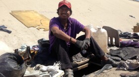 Abimael Martinez, who was deported from Riverside, Calif., sits next to the hole he dug to live in beneath the banks of Tijuana's fetid river canal.