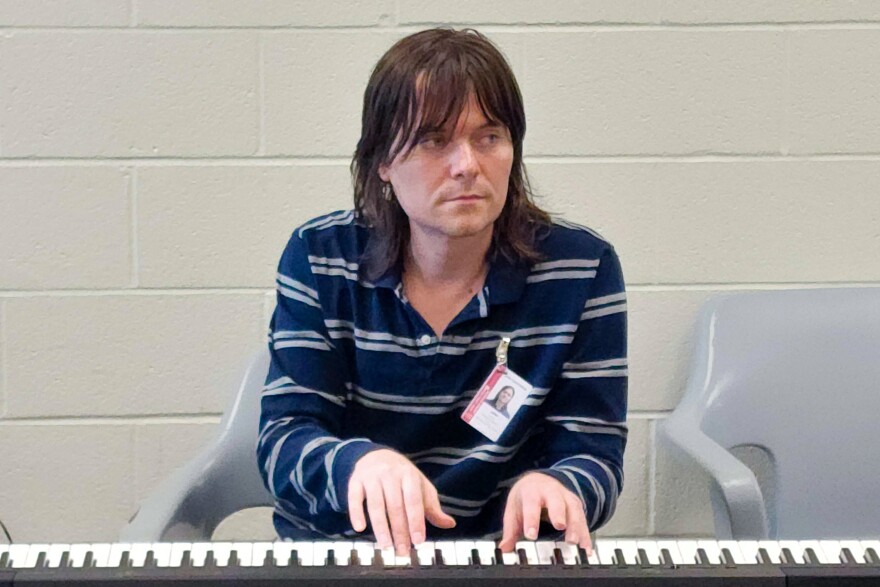 Piano instructor Joe Zempel plays the keyboard during the last day of the piloted Melodies of Hope piano class at the Buzz Westfall Justice Center on May 19 in Clayton.