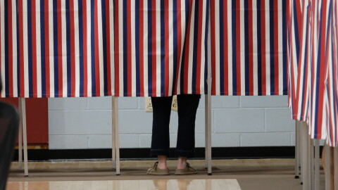 A voter filling out their ballot behind the patriotic curtain at Rye Elementary School on Sept. 8, 2026.