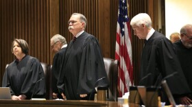 In this July 18, 2017 file photo, Chief Justice Lawton Nuss, third from left, lead justices to their seats to hear arguments on a school funding case before the Kansas Supreme Court in Topeka, Kan. The Court ruled Monday, Oct. 2, 2017, that legislators did not increase spending on the state's public schools enough this year, hinting in its opinion that lawmakers fell hundreds of millions of dollars short a year of providing a suitable education for every child. The court rejected the state's arguments that a new law phasing in a $293 million increase in funding over two years was enough to provide a suitable education for each of the state's 458,000 students. (Orlin Wagner, File/AP)