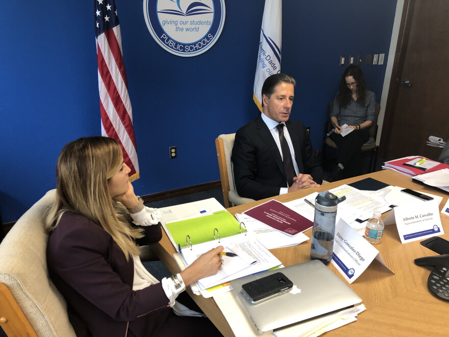 Miami-Dade County schools superintendent Alberto Carvalho (center) and the school district's chief communications officer, Daisy Gonzalez-Diego (left), attend the final meeting of a task force considering the future of WLRN.