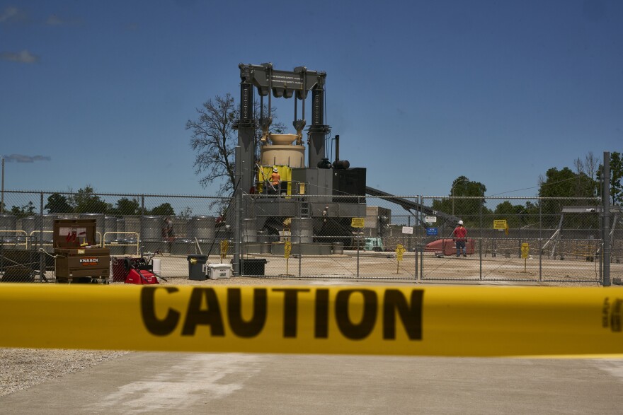 Workers stand watch by the dry cask that holds spent fuel being loaded into long term storage, at Callaway Energy Center on Wednesday June 5, 2024. The purpose of the dry cask storage project is to design, build and place into operation an Independent Spent Fuel Storage system at the Callaway Energy Center.