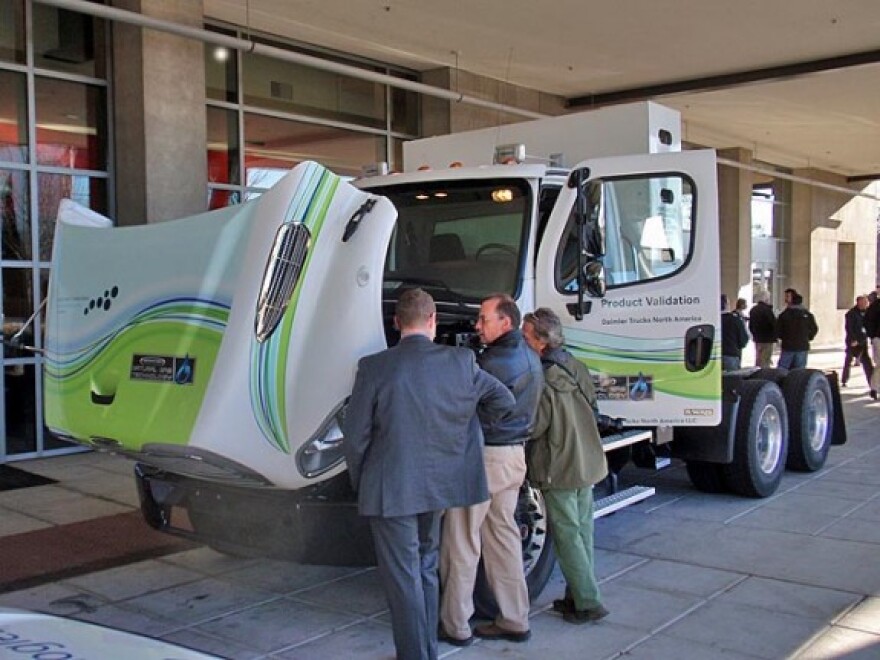 Freightliner demonstrated a natural gas fueled semi-tractor. The fuel tank is the tall, rectangular box behind the cab.