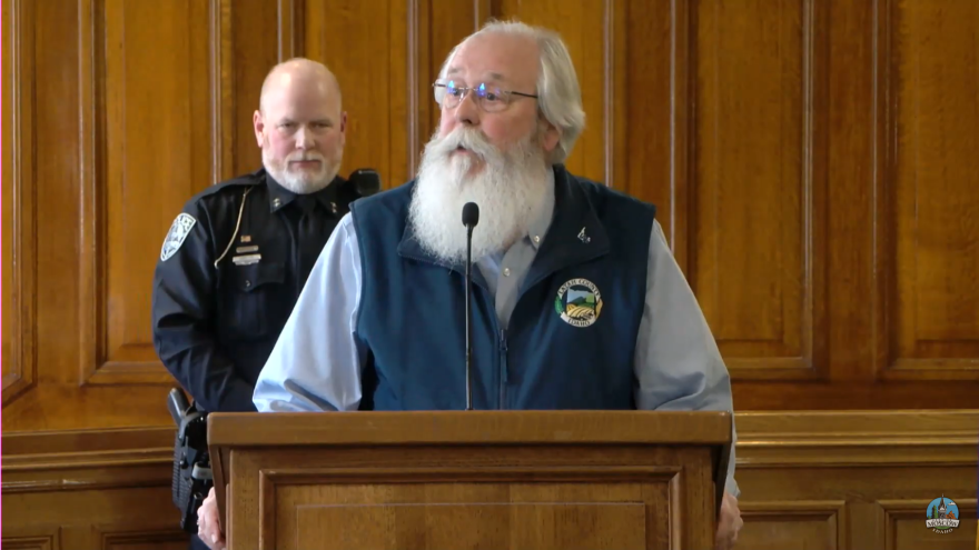 Latah County Prosecutor Bill Thompson updates reporters on the case during a press conference December 30, 2022. Behind him, stands Moscow Police Chief James Fry.