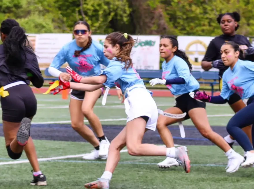 Olivia Iafrate (center) competes for Johnston High School in a girls' flag football game.
