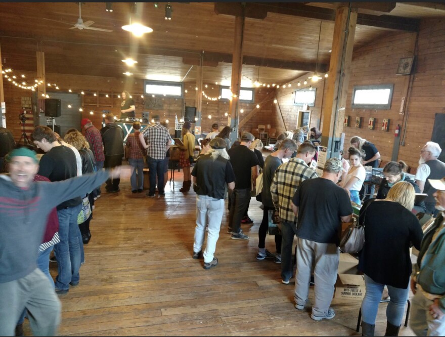 People gather inside Rail River Folk School and look at records on Record Store Day