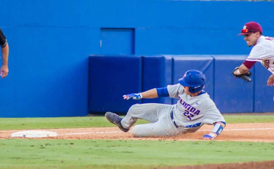 JJ Schwarz slides and gets taken out at third base by Darren Miller in the eighth inning on June 6.