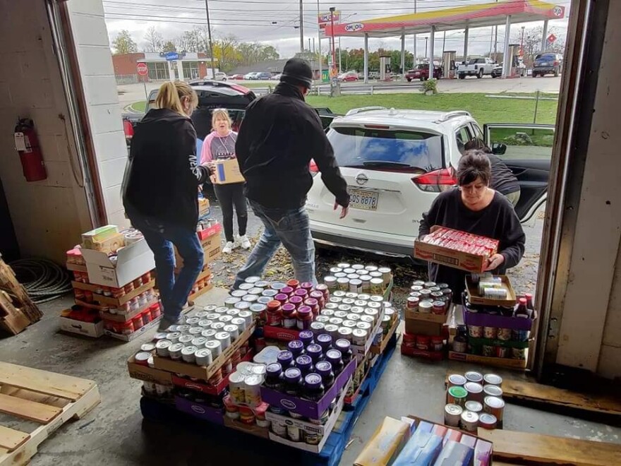 The staff at With God's Grace accepts a donation from New City Church. The free store is scheduled to open in December, but they'll be giving away turkey dinners on Thanksgiving morning. 