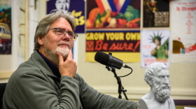 Jeff Crane sits in a studio and strokes his chin thoughtfully. 