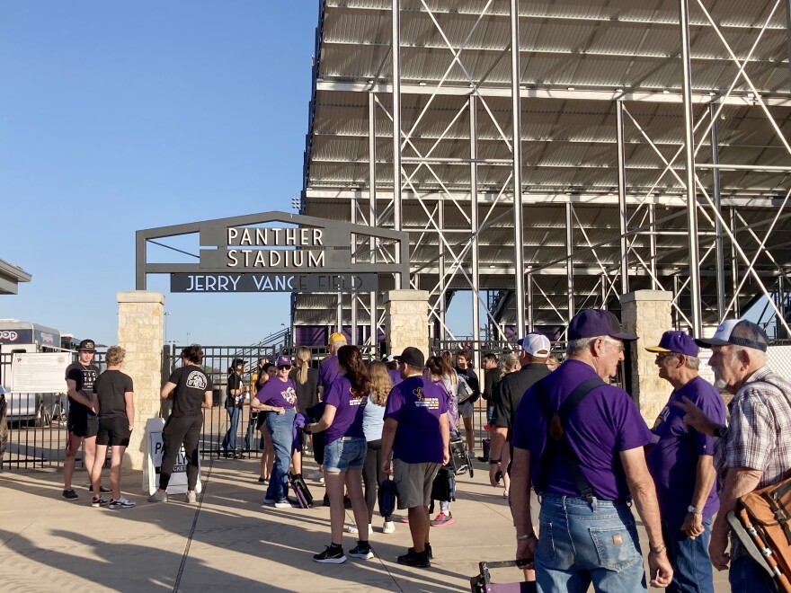 People wait in line to enter Panther Stadium at Liberty Hill High School for a football game.