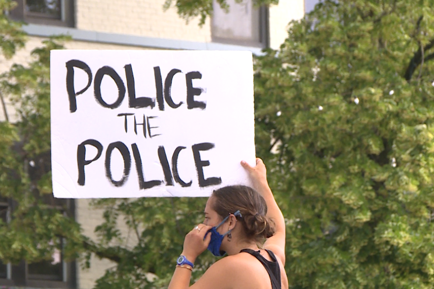 A protester holding a sign outside the Monroe County Courthouse on June 9, 2020
