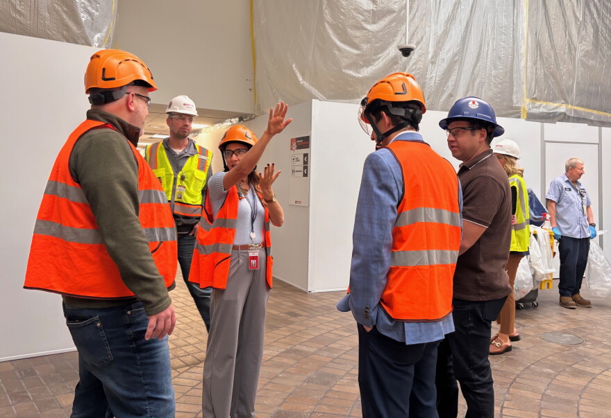 Quad Cities airport marketing manager Ashleigh Johnston gestures during a tour with Congressman Eric Sorensen, of current Project Gateway construction, Oct. 16, 2026.