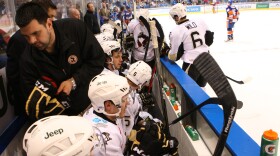 Teddy Richards, standing, left, holds a pair of