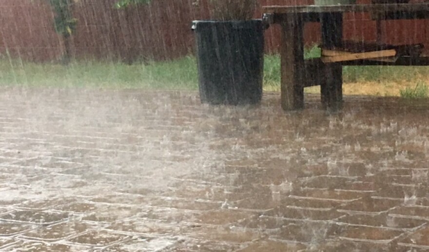 Rain falls on backyard pavers in central Phoenix.