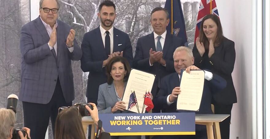 New York Governor Kathy Hochul (left) and Ontario Premier Doug Ford (right) sign an agreement to collaboratively work on nuclear energy projects.
