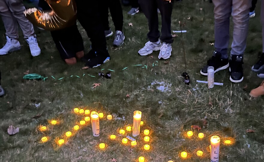 Mourners spell out Jazmir Tucker's nickname in candles.