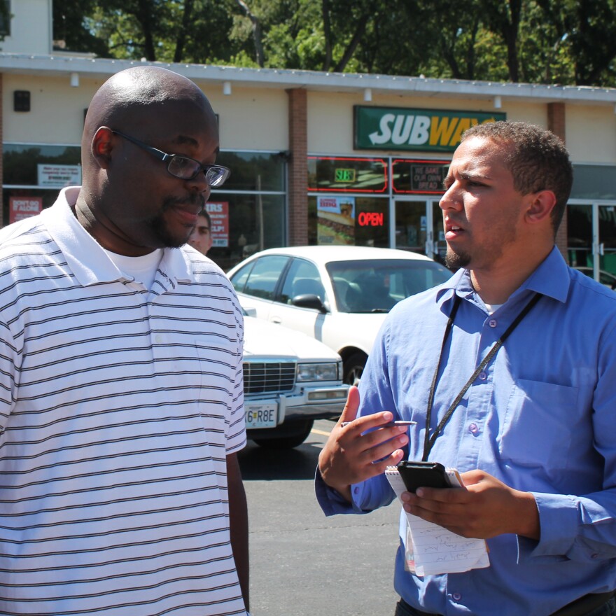 Wesley Lowery (right) speaks to a Ferguson resident in 2014, a couple of hours before being arrested.