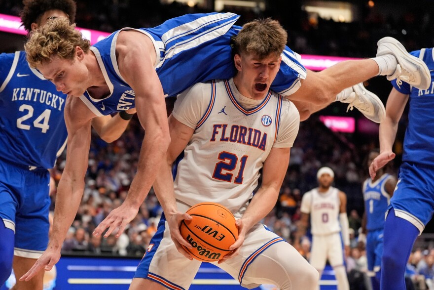 Kentucky guard Collin Chandler (5) falls onto Florida forward Alex Condon (21) during the second half of an NCAA college basketball game in the quarterfinal round of the Southeastern Conference tournament, Friday, March 13, 2026, in Nashville, Tenn. (AP Photo/George Walker IV)