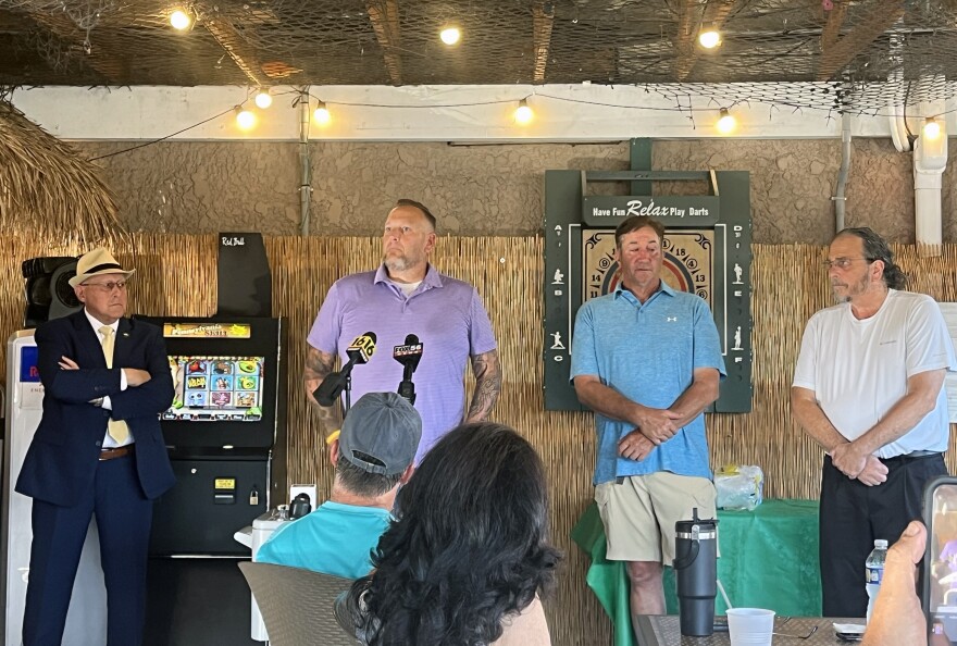 Wilkes-Barre Mayor George Brown hosted a meeting at CrisNics Irish Pub on Monday evening, July 28, to update neighborhood residents about ongoing construction work on Horton Street following two large sinkholes and ongoing issues with a sewer/stormwater line. From left are Brown; Robert Judge, from UGI Utilities, speaking in front of the news microphones; Rob Stella from Stell Enterprises; and Michael Amato from Penn Eastern Engineering.