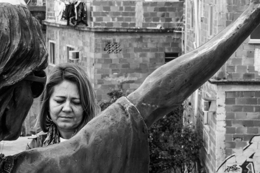 Salete Martins, a tour guide in the Santa Marta <em>favela,</em> stands in front of the Michael Jackson statue. She says tourists aren't coming because consulates told their citizens to stay away from <em>favelas.</em>