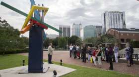 Orange County's Terry Olson leading a walking tour of the 2017 exhibition at its opening last June. 