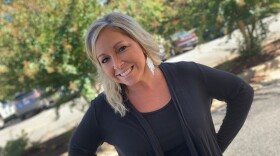 Woman with hands on hips and smiling