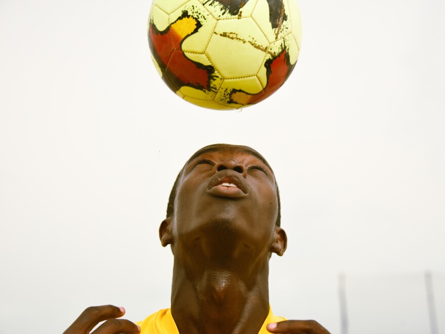 Sylvestre Ndione, a 23-year-old philosophy student at the University of Dakar, plays soccer with his friends on a beach.