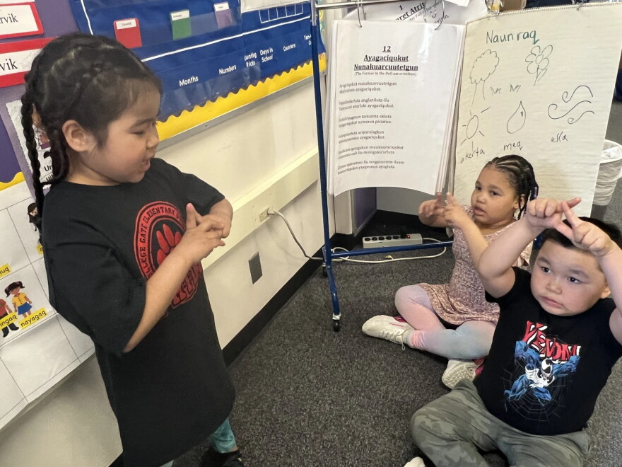 Emi entered the first grade at College Gate Elementary this fall. Her parents worried that she might lose her ability to speak Yugtun, the Yup'ik language. But as a fluent speaker, she's been a welcome addition to the school's Yup'ik language immersion program. On May 21, 2026, she was leading a lesson with her classmates.