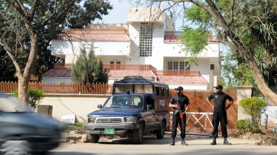 Pakistani security personnel stand guard outside the house in Islamabad where family members of al-Qaida chief Osama bin Laden are being held.