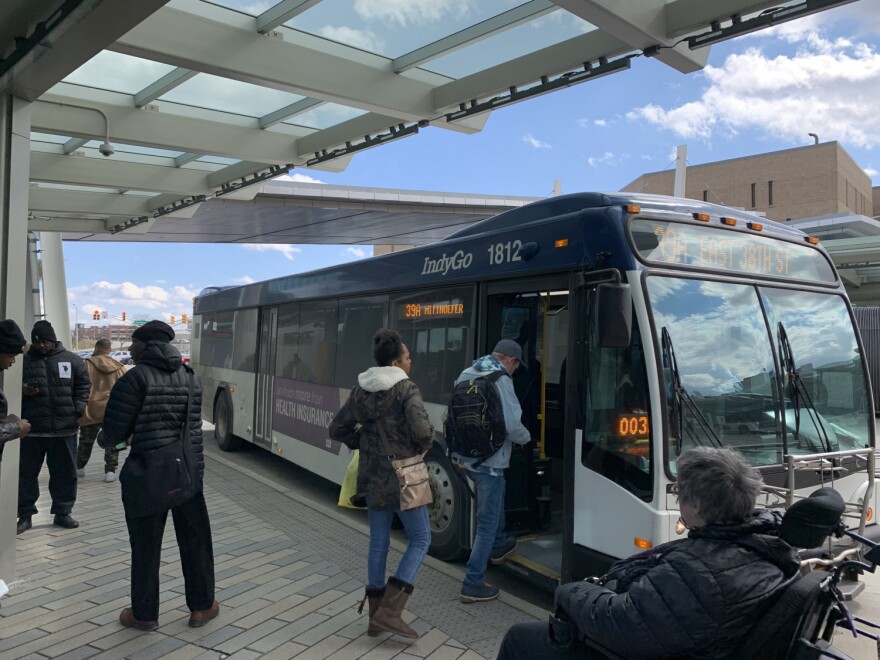 Passengers board an IndyGo bus.