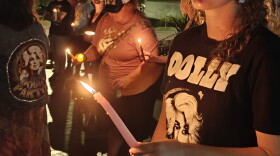 Dolly Parton fan with candle at vigil at IU 