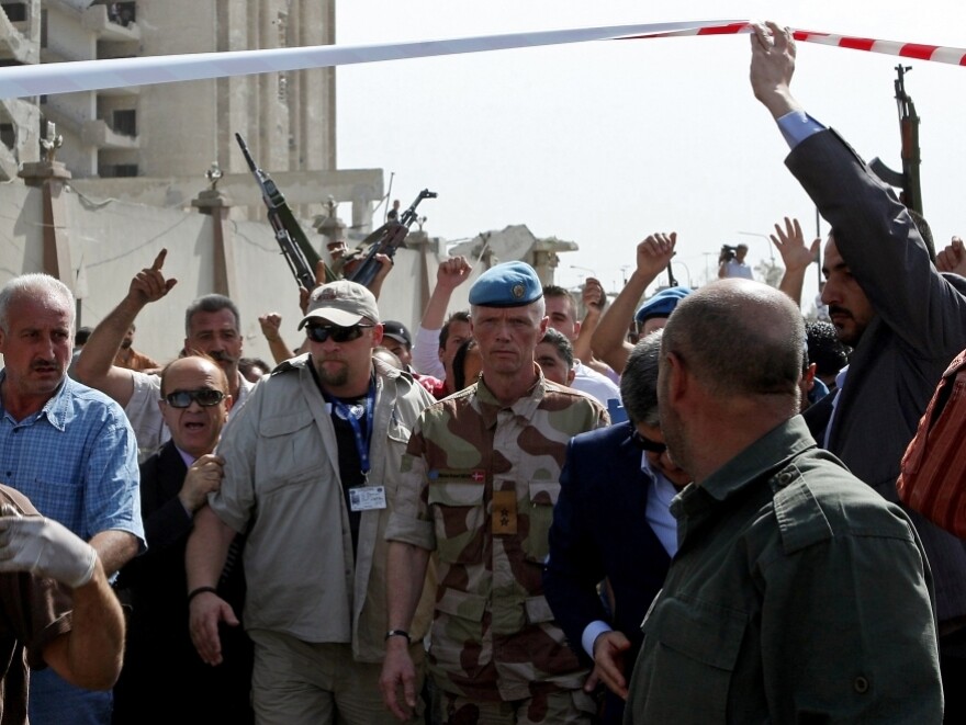 Norwegian Maj. Gen. Robert Mood (center), head of the U.N. observers mission in Syria, arrives to inspect the site of twin blasts.