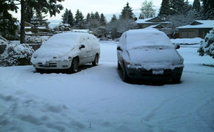 In a scene repeated around the Sound, drivers let their snow-covered cars parked. Transportation officials are asking commuters to stay off the roads today, if you can.