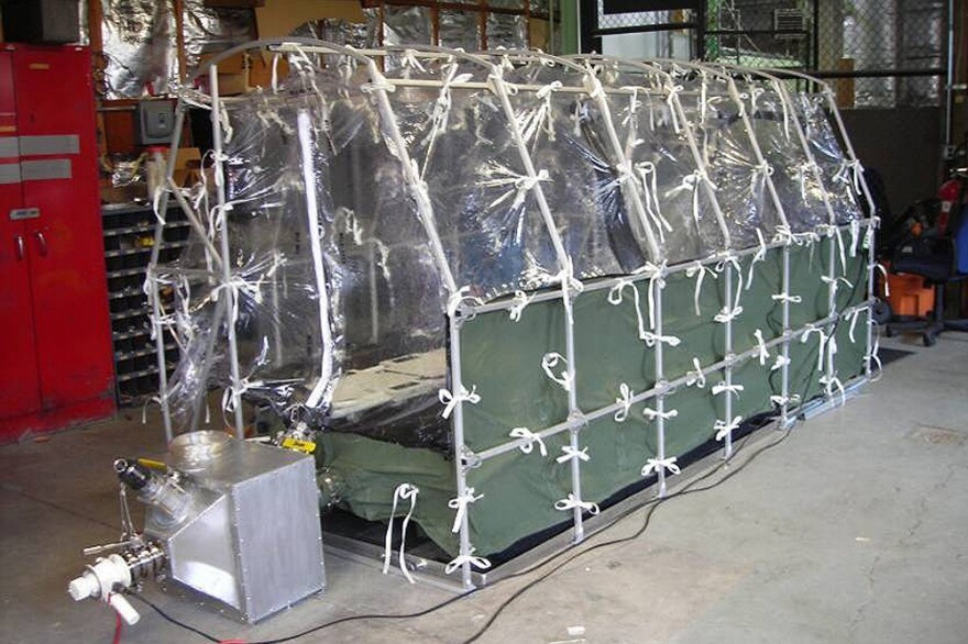 To transport Ebola patients, health workers put an isolation tent inside the plane's cabin. The unit is called an Aeromedical Biological Containment System.
