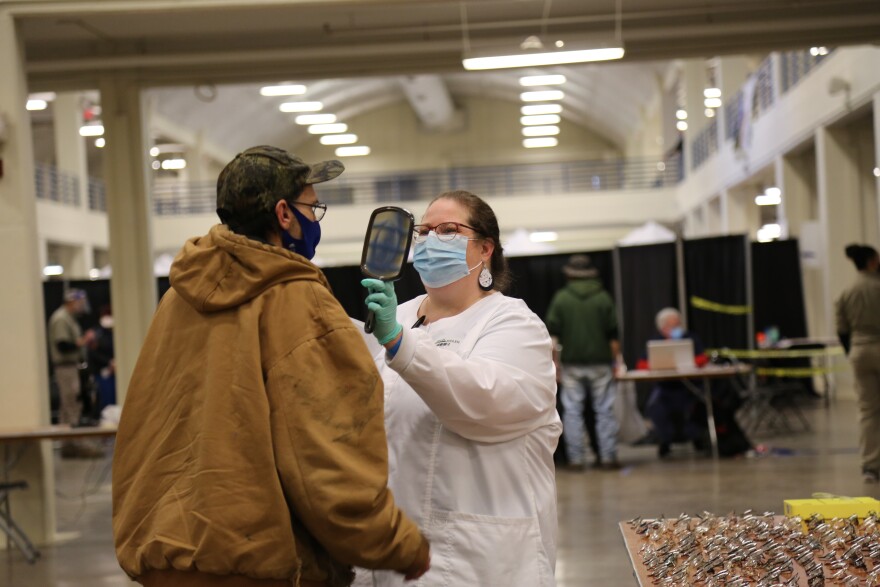 A patient receives vision services at a previous RAM clinic.