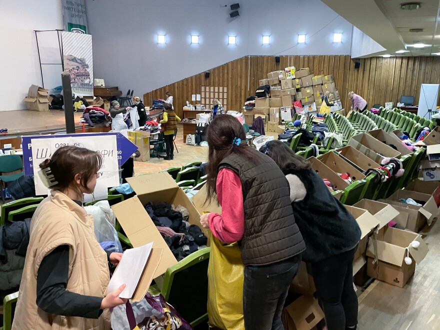 Women sort donated socks in a theater now being used as an aid distribution hub in downtown Lviv, Ukraine.