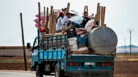 Syrian Kurdish and Arab families are pictured fleeing in the countryside of the town of Darbasiyah, on the border between Syria and Turkey, towards the town of Hassakeh on October 22, 2019. (Delil Souleiman/Getty Images) 